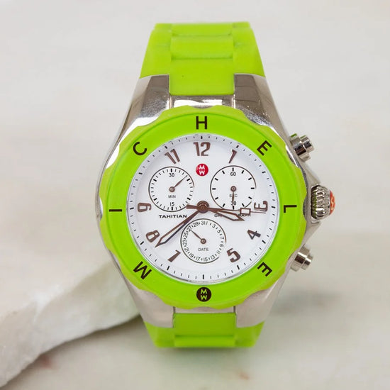 Green watch with a white face on a light background
