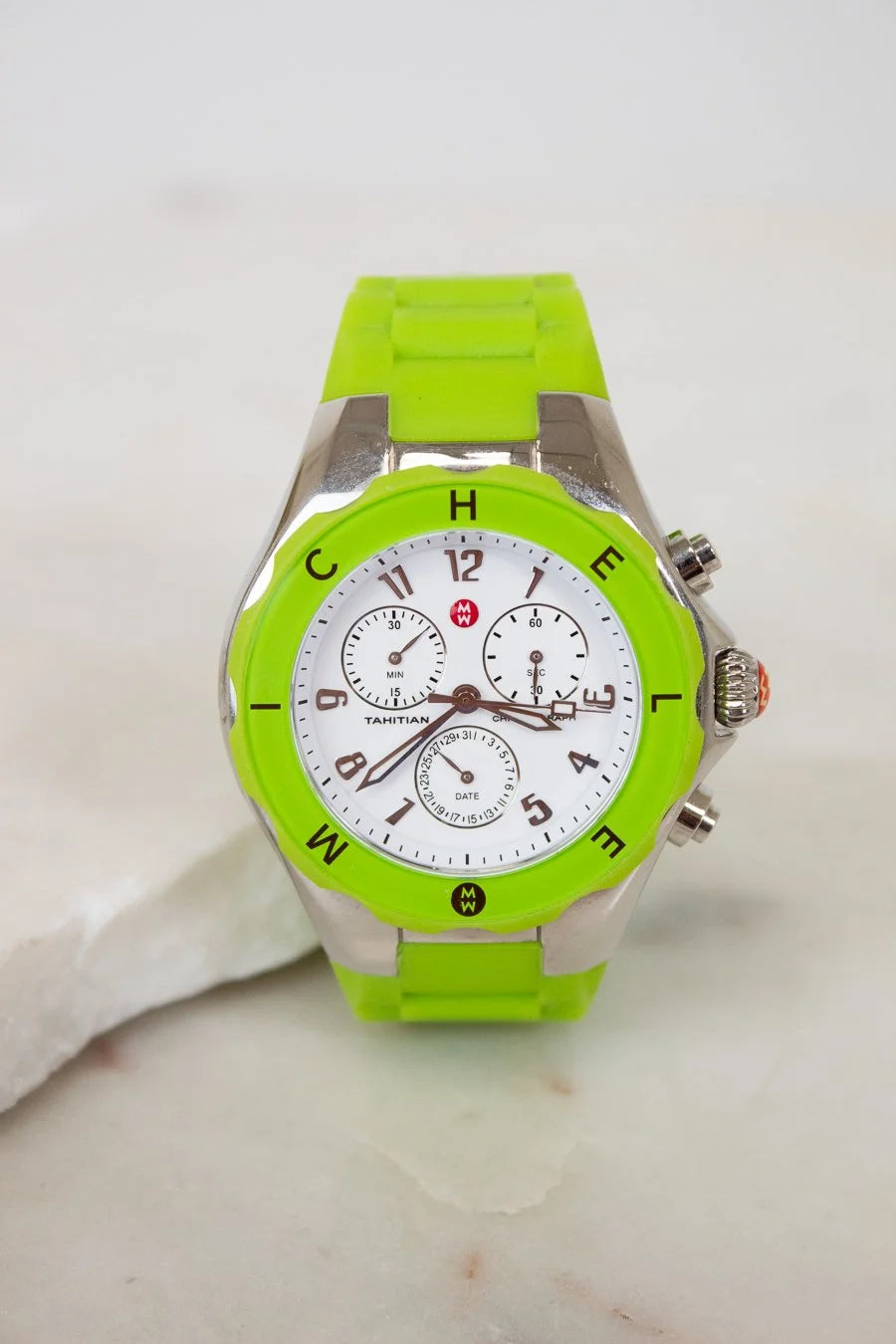 Green watch with a white face on a light background
