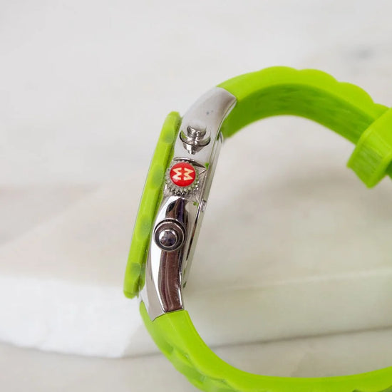 Green bracelet with a metal clasp on a white background