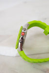 Green bracelet with a metal clasp on a white background