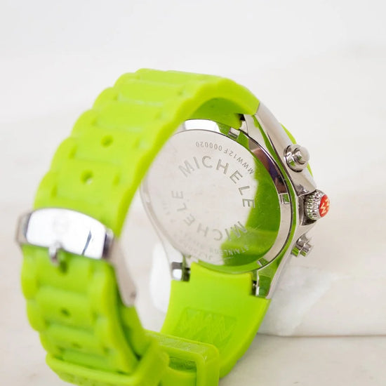 Green watch with a visible brand logo on a white background