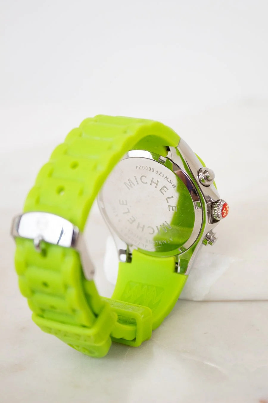 Green watch with a visible brand logo on a white background