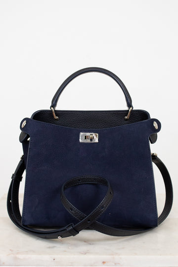 Navy blue handbag with silver-tone accents on a light gray background