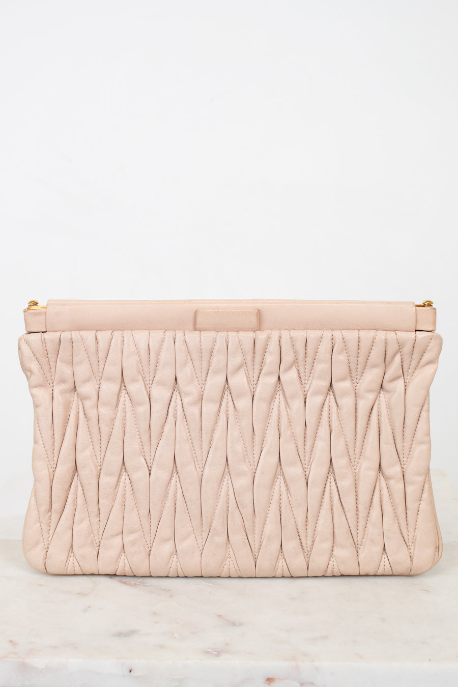 Quilted clutch bag on a light background