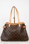 Designer handbag with monogram pattern on a light background