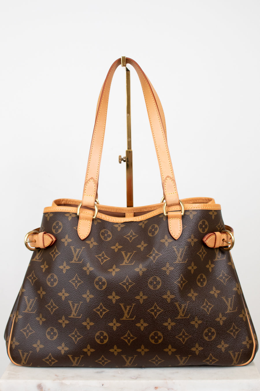 Designer handbag with monogram pattern on a light background