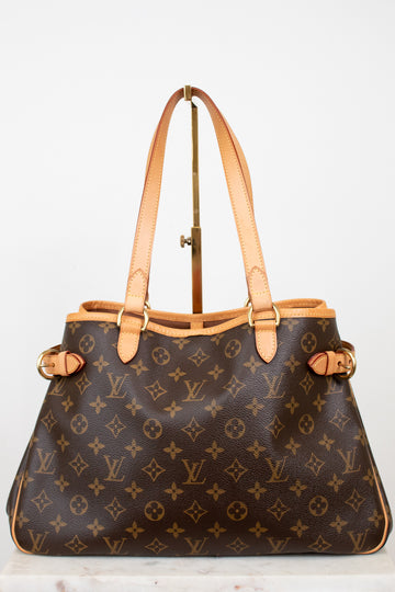 Designer handbag with monogram pattern on a light background