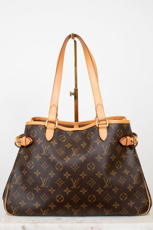 Designer handbag with monogram pattern on a light background