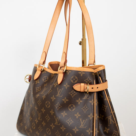 Designer handbag with monogram pattern on a light background