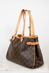 Designer handbag with monogram pattern on a light background