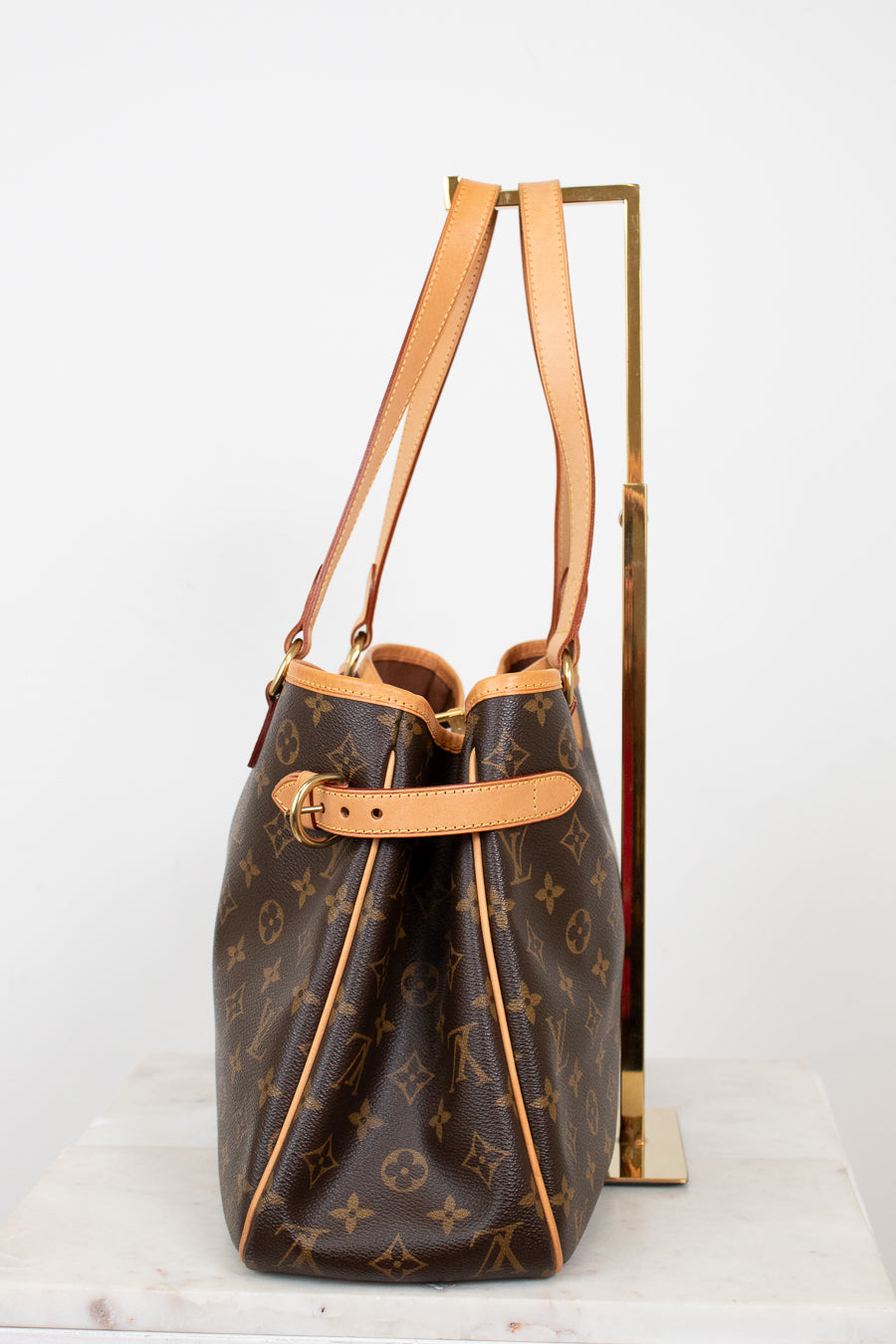 Designer handbag with monogram pattern on a white background