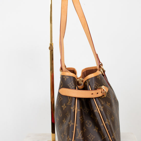 Designer handbag with monogram pattern on a white background