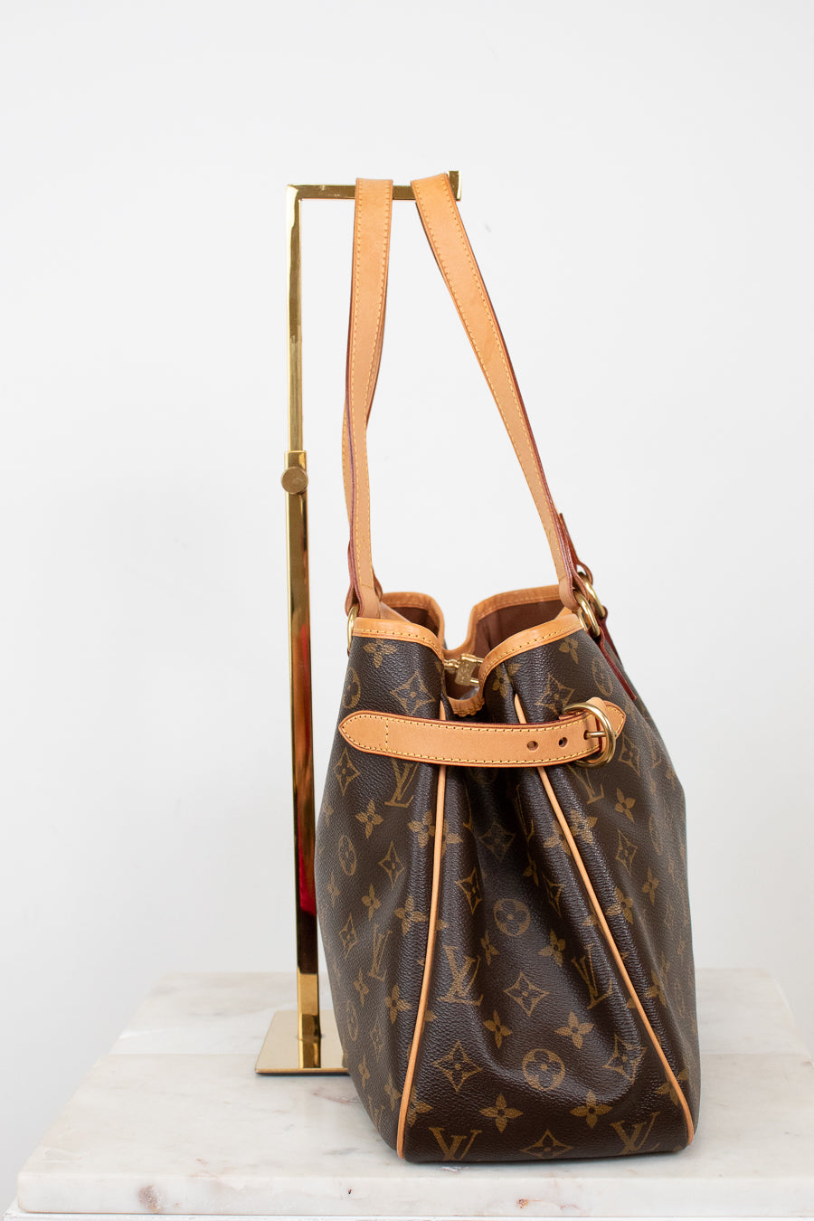 Designer handbag with monogram pattern on a white background