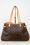 Designer handbag with monogram pattern on a white background