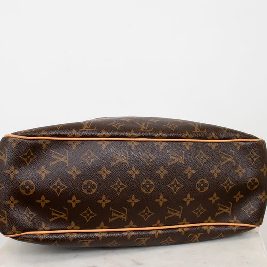 Brown Louis Vuitton monogram handbag on a white surface