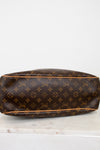 Brown Louis Vuitton monogram handbag on a white surface