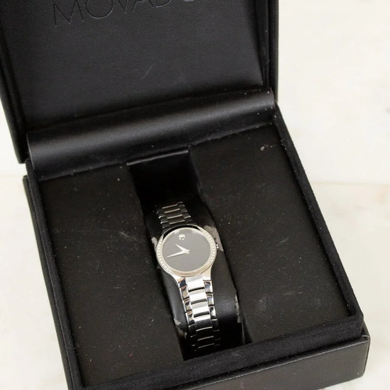 Movado watch in a black box on a light background
