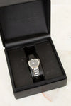 Movado watch in a black box on a light background