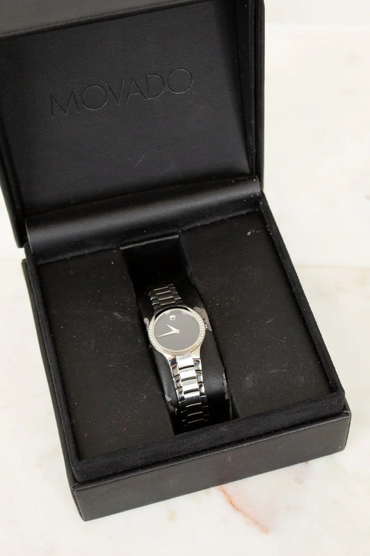 Movado watch in a black box on a light background