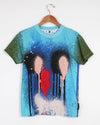 T-shirt with artistic design of three abstract figures and a red heart on a hanger against a white background