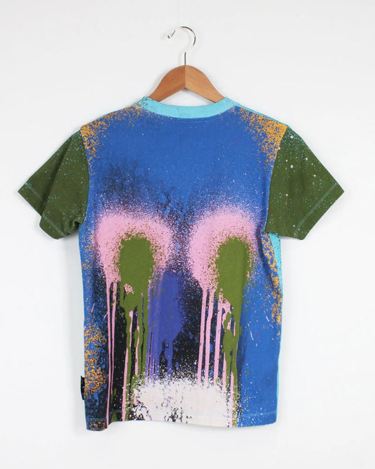 Colorful t-shirt with abstract design on a hanger against a white background