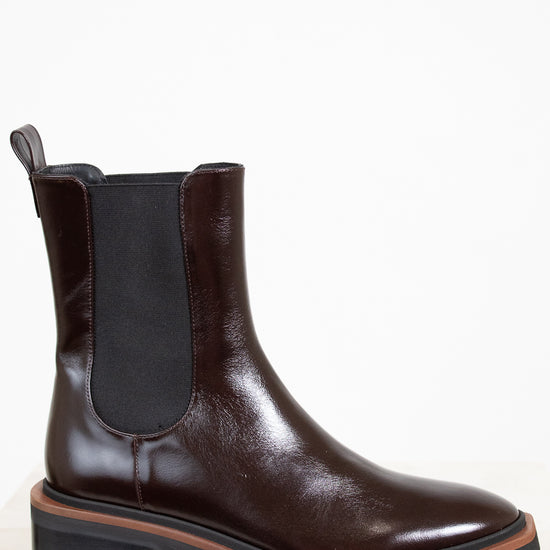 Brown leather boot with a white background