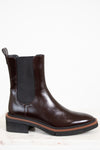 Brown leather boot with a white background