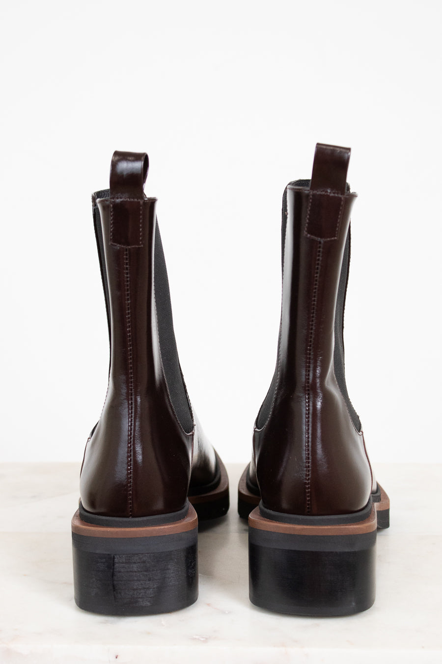 Pair of brown leather boots on a white background