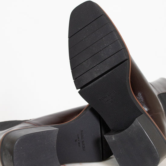 Close-up of black leather shoes with a white background