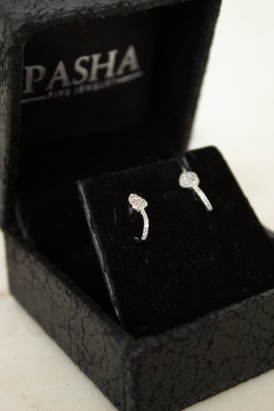 Silver pave diamond earrings in a black jewelry box with 'Pasha' branding.