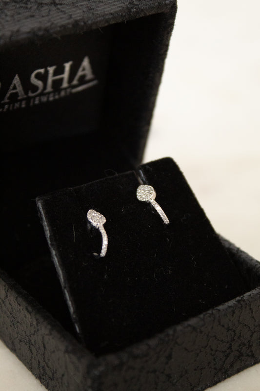 Pair of silver pave diamond earrings on a black Asha jewelry box
