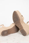 Beige sandals with textured soles on a light background