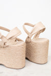 Beige wedge sandals with raffia sole on a light background