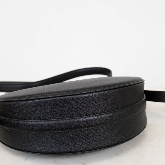 Black leather purse on a marble surface