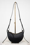 Black handbag with a gold clasp on a white background