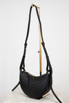 Black handbag with gold accents on a white background