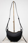Black leather saddle bag with a strap on a white background