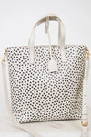 White tote bag with black polka dot pattern on a white background