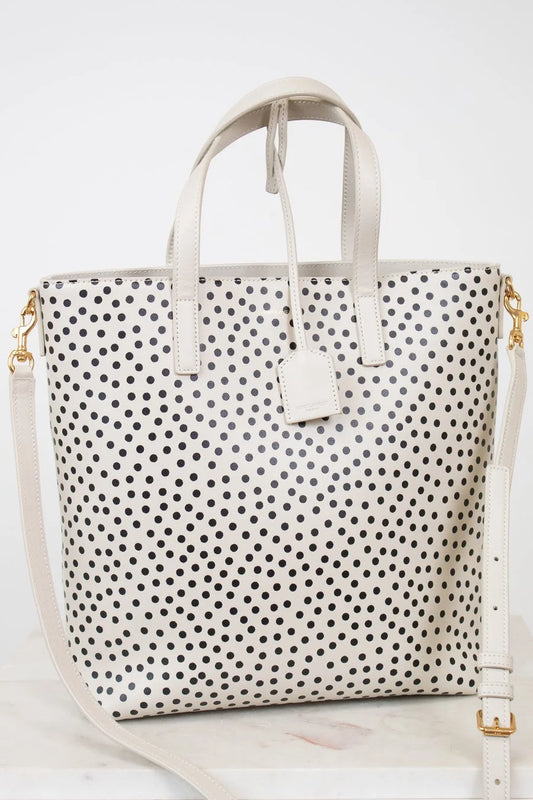 White tote bag with black polka dot pattern on a white background