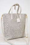 White tote bag with black polka dot pattern on a white background