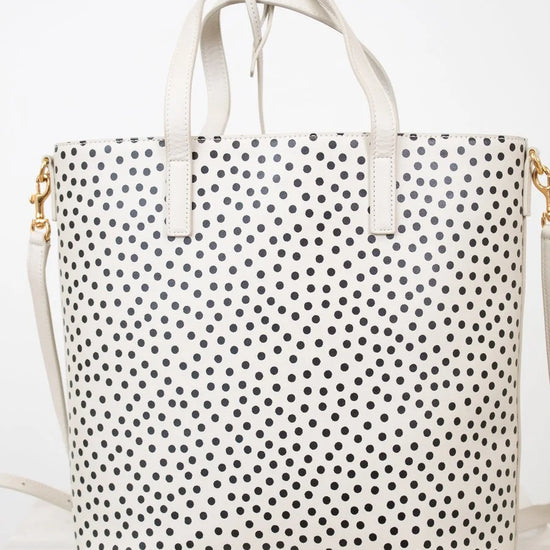 White tote bag with black polka dot pattern on a white background