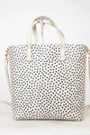 White tote bag with black polka dot pattern on a white background