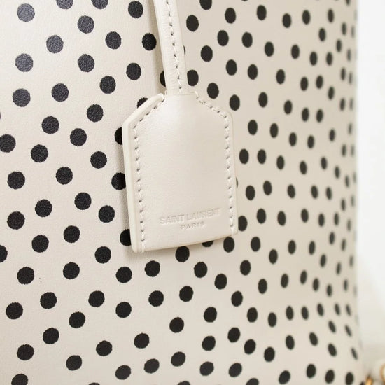 Polka dot bag with a visible brand tag on a white background
