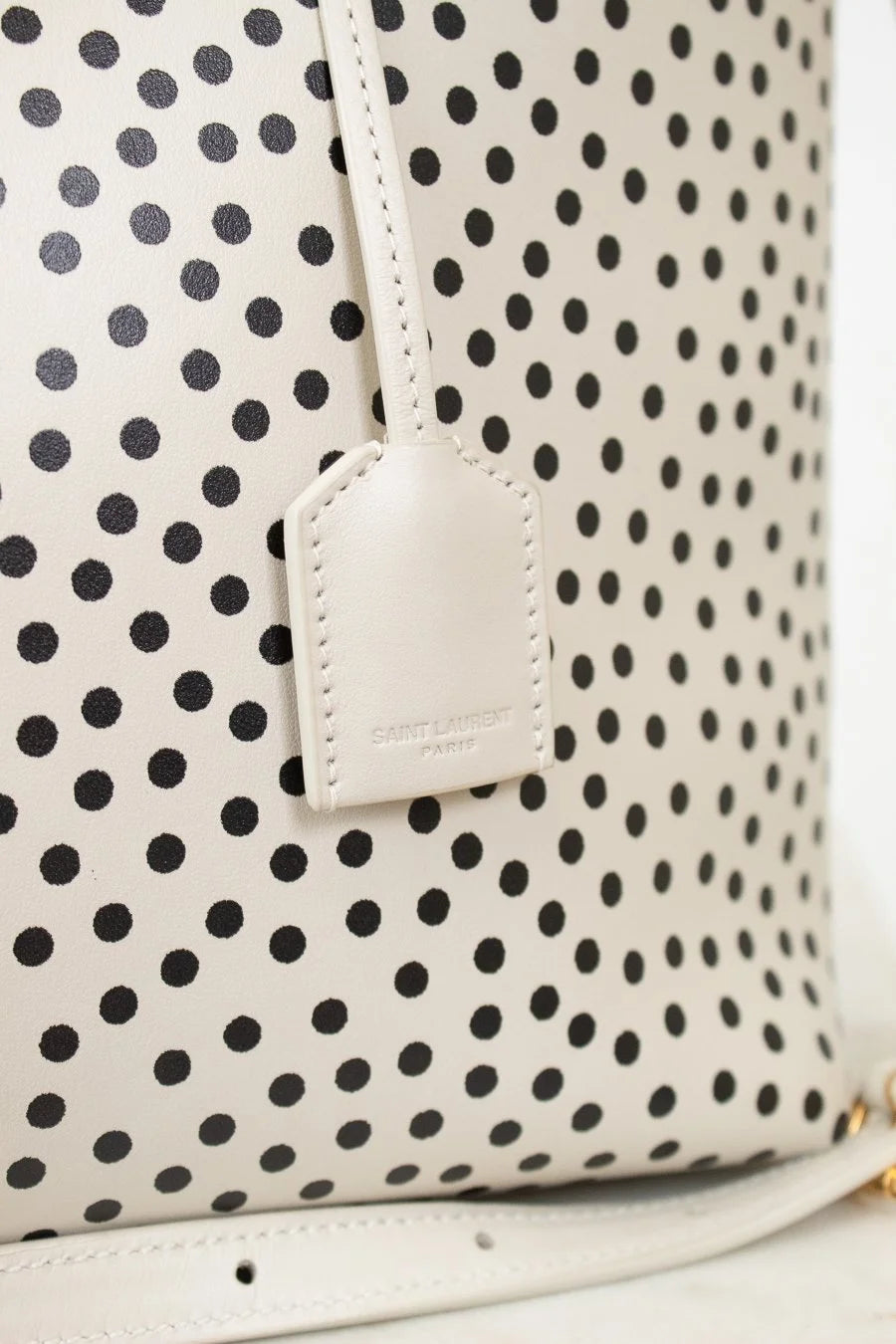 Polka dot bag with a visible brand tag on a white background
