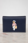 Navy blue wallet with bear design on a marble surface