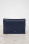 Navy leather wallet with 'Polo by Ralph Lauren' branding on a marble surface.