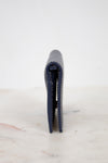 Navy blue wallet on a white marble surface