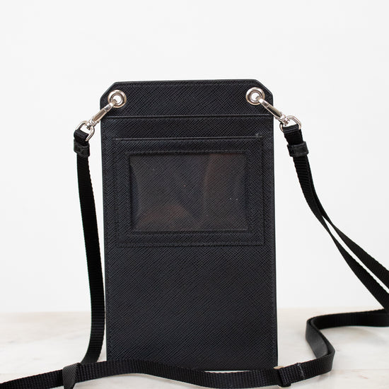 Black crossbody bag with a strap on a white background