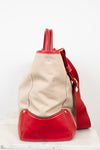Red and beige handbag on a white background
