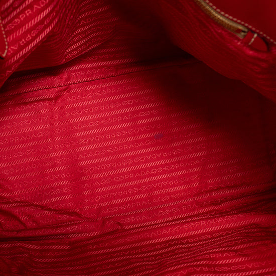 Close-up interior of a red textured fabric with a brand label.
